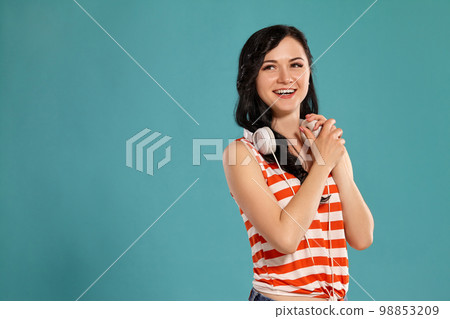 Studio photo of a gorgeous girl teenager posing over a blue background. 98853209
