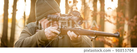 Hunter or ranger with professional, nightvision hunting gun aiming wild animal and hunting form to hunt in an autumn forest, hunting concept 98853704