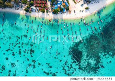 Aerial view of Sunrise beach with long tail boats in Koh Lipe, Satun, Thailand Aerial view of Sunrise beach with long tail boats in Koh Lipe, Satun, Thailand 98855631