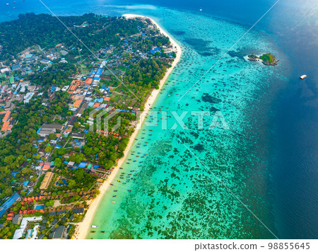 Aerial view of Sunrise beach with long tail boats in Koh Lipe, Satun, Thailand Aerial view of Sunrise beach with long tail boats in Koh Lipe, Satun, Thailand 98855645