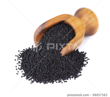 Black cumin seeds in wooden scoop, isolated on white background. Heap of black nigella seeds. Nigella sativa. 98857383