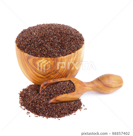 Psyllium seeds in wooden bowl and spoon, isolated on white background. Plantain. Plantago psyllium. 98857402