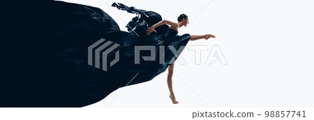 Expressive dane. Young woman, professional ballerina performing in black amazing dress over white background. Banner 98857741