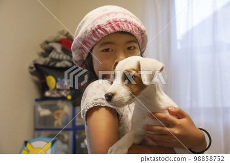 A girl holding a dog A girl holding a dog 98858752