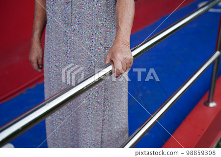 Asian elderly old woman patient use support rail on ramp, handrail safety grab bar, security in nursing hospital. Asian elderly old woman patient use support rail on ramp, handrail safety grab bar, security in nursing hospital. 98859308