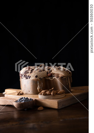 Colomba with chocolate. Easter Italian cake with almonds and chocolate in the shape of a dove.  98860030