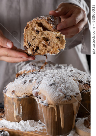 Colomba with chocolate. Easter Italian cake with almonds and chocolate in the shape of a dove.  98860032