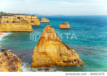 Natural caves and beach, Algarve Portugal. Rock cliff arches of Seven Hanging Valleys and turquoise sea water on coast of Portugal in Algarve region 98861879