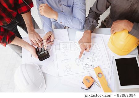 Construction concept of Engineer and Architect working at Construction Site with blue print, Engineer and Architect discussing construction plan with computer laptop calculator 98862094