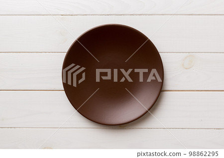 Top view of empty plate on wooden background. Empty space for your design Top view of empty plate on wooden background. Empty space for your design 98862295