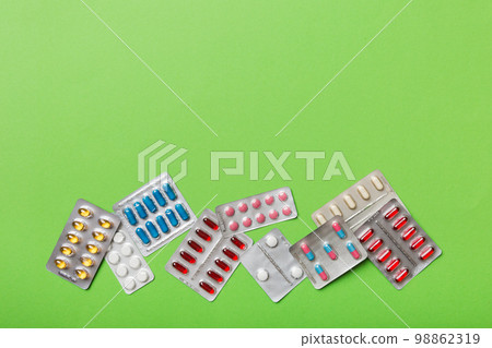 Protective face masks or surgical masks, medicine pills and thermometer on table background. Coronavirus disease. Corona virus concept. Space for text Protective face masks or surgical masks, medicine pills and thermometer on table background. Coronavirus disease. Corona virus concept. Space for text 98862319