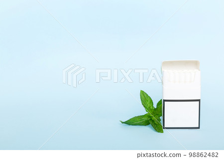 Pack of menthol cigarettes and fresh mint on colored table, Menthol cigarettes top view flat lay 98862482