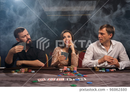 Group of a young rich friends are playing poker in casino. Group of a young rich friends are playing poker in casino. 98862880