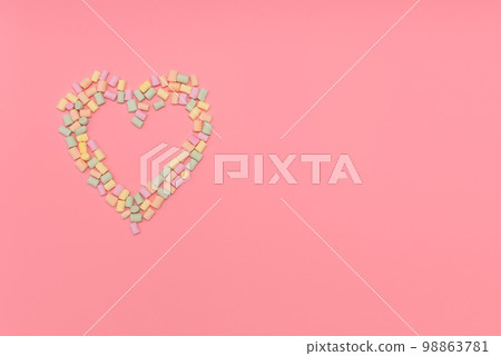 Heart of multicolored marshmallows isolated on pink background. Love, congratulation concept. Banner, postcard. Top view, copy space. 98863781