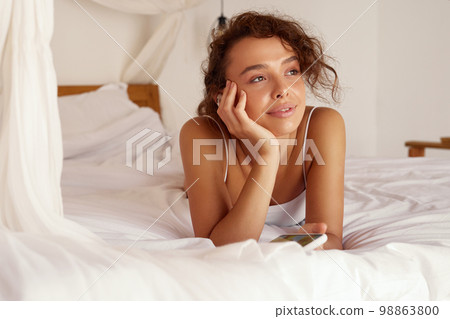 Woman Listening Music. Young Woman Using Smartphone And Earphones 98863800