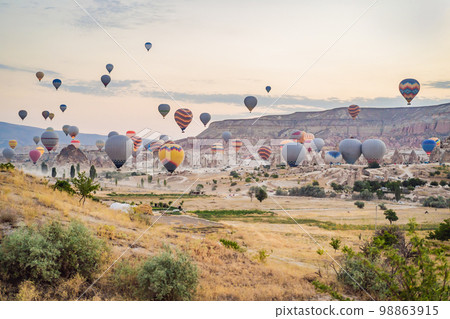 Colorful hot air balloon flying over Cappadocia, Turkey 98863915