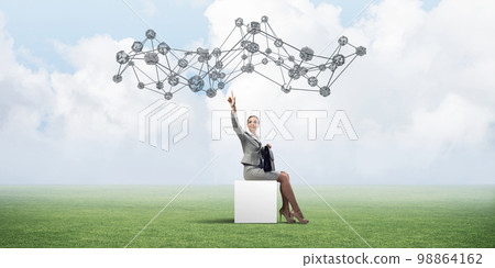 Attractive business lady or accountant outdoors on white box Attractive business lady or accountant outdoors on white box 98864162