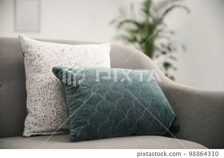 Soft pillows on grey sofa in living room Soft pillows on grey sofa in living room 98864310