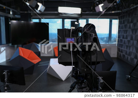 Modern video recording studio with professional equipment, focus on camera 98864317