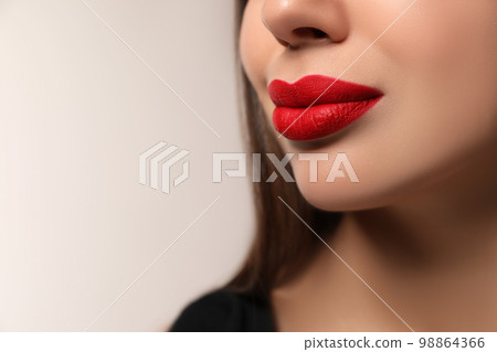 Beautiful woman with red lipstick on light background, closeup. Space for text Beautiful woman with red lipstick on light background, closeup. Space for text 98864366