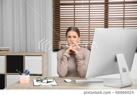 Professional psychotherapist at table with computer in modern office Professional psychotherapist at table with computer in modern office 98866024
