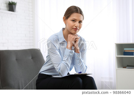 Professional psychotherapist with clipboard in modern office 98866040