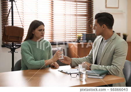 Professional psychotherapist working with patient in office 98866043