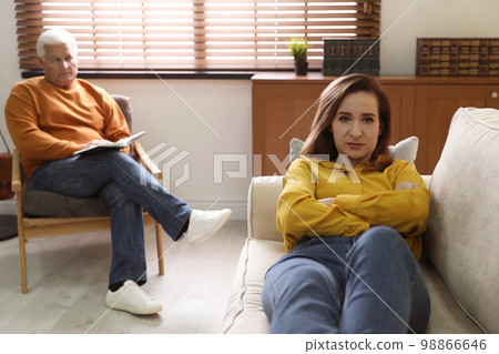 Professional psychotherapist working with patient in office 98866646