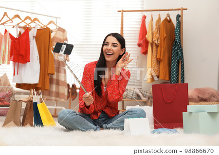 Fashion blogger recording new video with smartphone in room 98866670