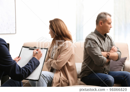 Psychotherapist working with couple in office. Family counselling Psychotherapist working with couple in office. Family counselling 98866820