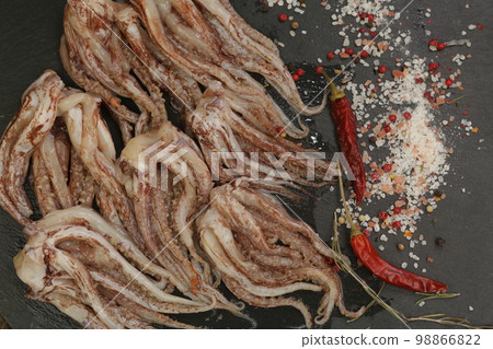 raw squid tentacles background closeup photo raw squid tentacles background closeup photo 98866822