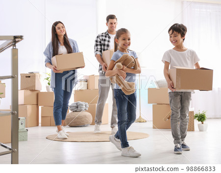 Happy family in room with cardboard boxes on moving day 98866833
