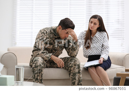 Psychotherapist working with male military officer in office 98867031