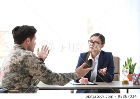 Psychotherapist working with male military officer in office 98867034