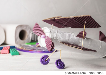 Doll and unicorn made of toilet paper among stationery on white wooden table, flat lay 98867056