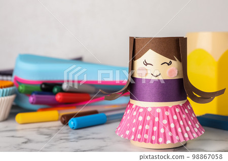 Doll and unicorn made of toilet paper among stationery on white wooden table, flat lay 98867058