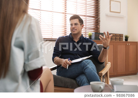 Professional psychotherapist working with patient in office Professional psychotherapist working with patient in office 98867086
