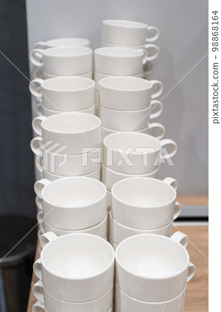 Stacks of Clean Mugs at Hotel Breakfast Buffet, White Cups Stacks of Clean Mugs at Hotel Breakfast Buffet, White Cups 98868164