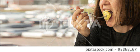 Woman eats tortellini closeup with copy space, dumpling on fork, agnolotti, cappelletti, stuffed pasta on fork 98868167
