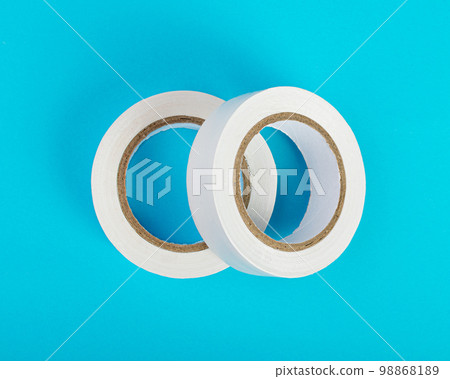 White Electrical Tape, Plastic Duct Tape Rolls, Colored Adhesive Tapes on Blue Background White Electrical Tape, Plastic Duct Tape Rolls, Colored Adhesive Tapes on Blue Background 98868189