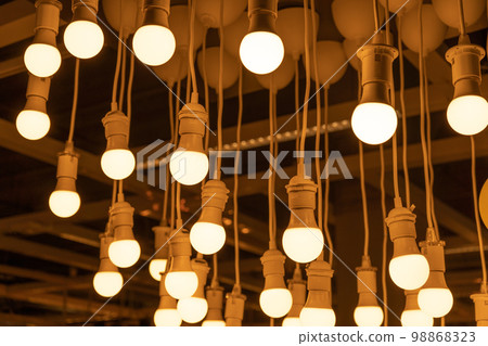 Hanging LED Light Bulbs on Blurred Background, Warm Energy Saving Lamp Hanging LED Light Bulbs on Blurred Background, Warm Energy Saving Lamp 98868323