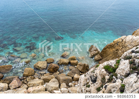 Foamy Sea Waves, Blue Clear Water on Rocky Beach Texture Background, Blue Ocean Water, Rocky Shore Foamy Sea Waves, Blue Clear Water on Rocky Beach Texture Background, Blue Ocean Water, Rocky Shore 98868353