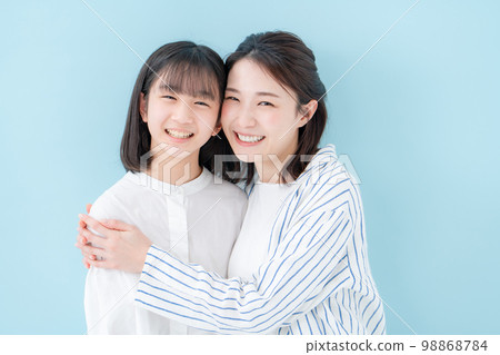 Good friends, mother and daughter, blue background 98868784