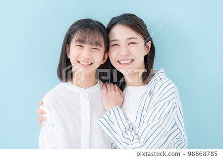 Good friends, mother and daughter, blue background 98868785