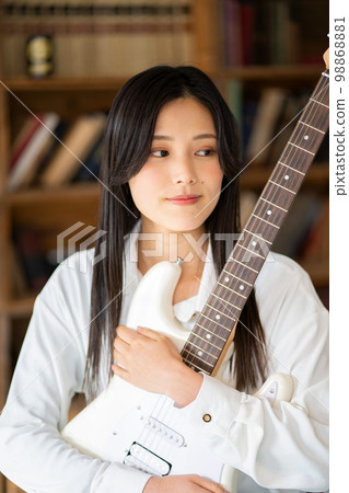 Young woman portrait (electric guitar) 98868881