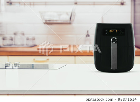 Air fryer machine cooking potato fried in kitchen. Lifestyle of new normal cooking.. 98871614