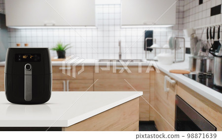 Air fryer machine cooking potato fried in kitchen. Lifestyle of new normal cooking.. 98871639