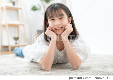 A girl lying down with a cane 98873018