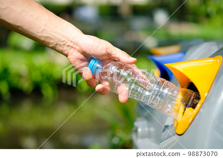 Please dispose of plastic bottle into the tank. A man throw rubbish in the trash can by separate garbage to dispose like hazardous waste , Please dispose of plastic bottle into the tank. A man throw rubbish in the trash can by separate garbage to dispose like hazardous waste , 98873070