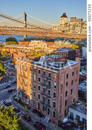 New York City Brooklyn building rooftop with patio and bridge near sunset 98873339